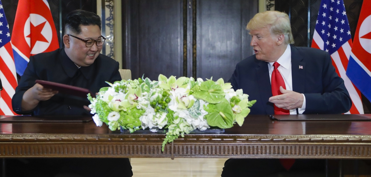 12일 싱가포르 센토사섬 카펠라호텔에서 김정은 북한 국무위원회 위원장과 도널드 트럼프(Donald Trump) 미국 대통령이 합의문에 서명한 후 웃어 보이고 있다. / 사진=뉴시스